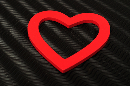 Valentines day. A red heart displayed against a black backgroundの写真素材