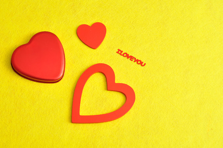 Valentine's Day. A variety of hearts isolated on a yellow background with the word I love youの写真素材