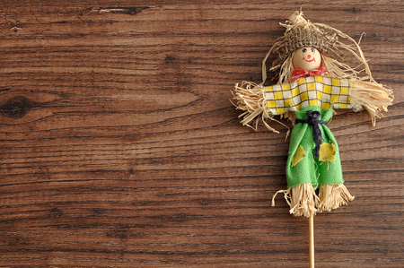 A smiling scarecrow isolated against a wooden backgroundの写真素材