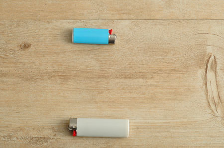 Lighters isolated on a wooden backgroundの写真素材