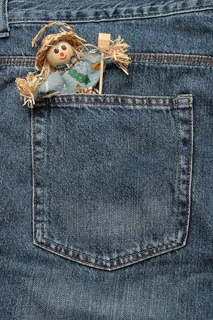 A smiling scare crow figure sticking out of the back of a denim jeanの写真素材
