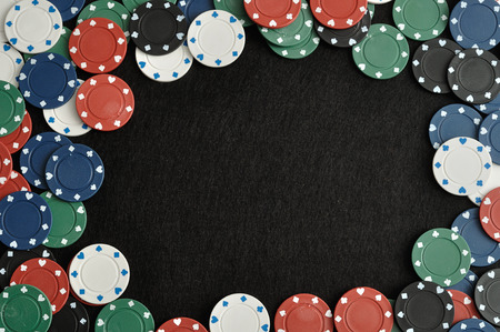 Poker chips forming a border with a black backgroundの写真素材