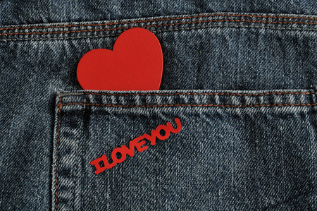 Valentines day. A red heart with the words I love you sticking out of a back pocket of a denim jeanの写真素材