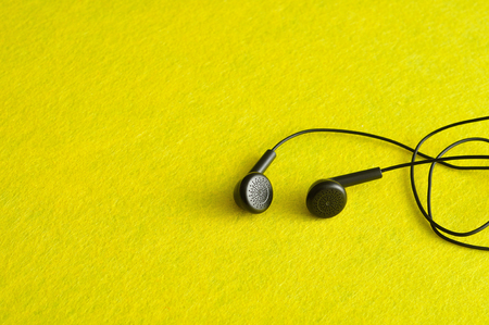 Earphones isolated against a yellow backgroundの写真素材