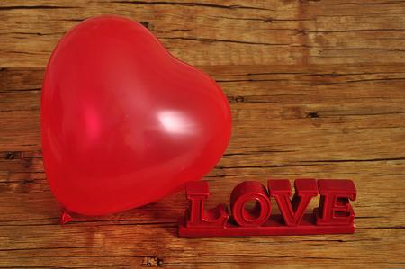 Valentines day. A red heart shape balloon with the word loveの写真素材