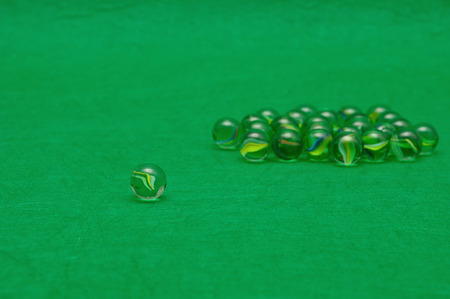 Marbles displayed on a green backgroundの写真素材