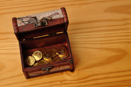 A treasure chest filled with golden coinsの写真素材