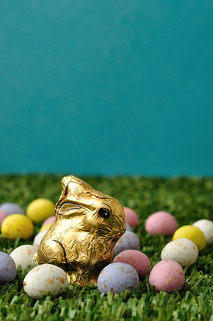 An easter bunny displayed with speckled easter eggs