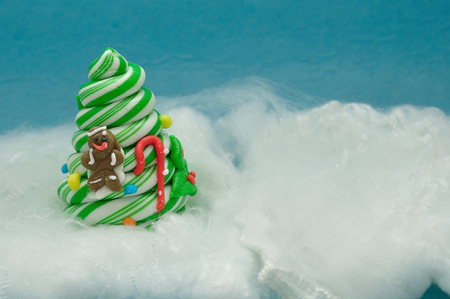 A candy cane christmas tree decorated with a gingerbread man and a caneの写真素材