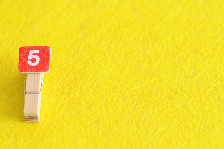 Number 5 displayed on a yellow background
