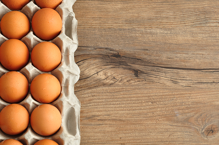 Eggs displayed in a carton on a wooden table