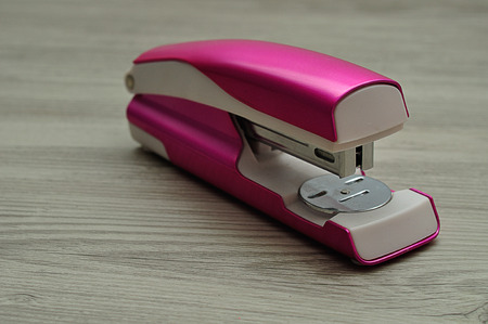 A pink stapler の写真素材