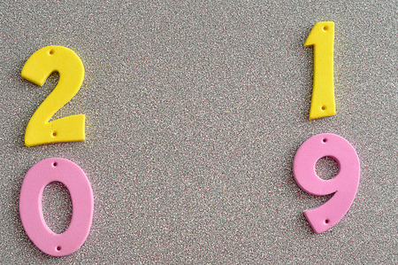 2019 in pink and yellow numbers on a silver background