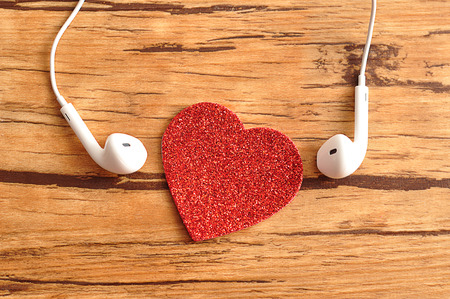 White earphones with a red heartの写真素材