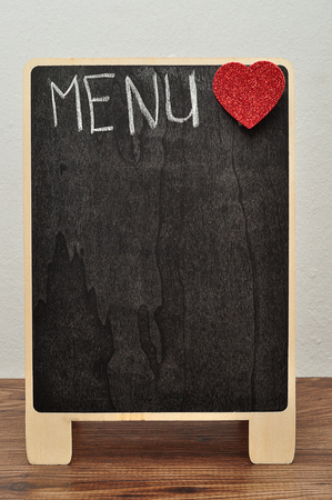 A blackboard with the word menu and a red heartの写真素材
