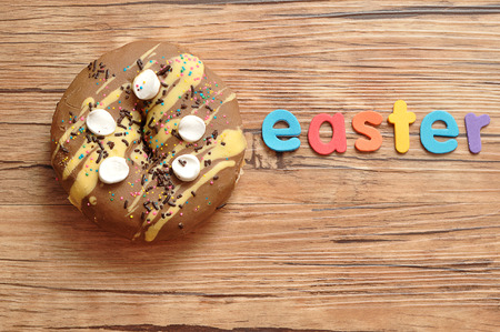 A fancy decorated doughnut with the word easter