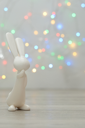 A small bunny figurine displayed against an out of focus light background for easterの写真素材