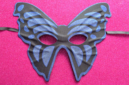 A blue and black mask in the shape of a butterflyの写真素材