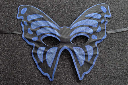 A blue and black mask in the shape of a butterflyの写真素材