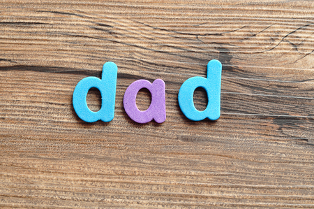 The word dad on a wooden backgroundの写真素材