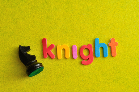 A knight chess piece with the word knight on a yellow backgroundの写真素材