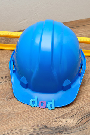 The word dad displayed with a level and a blue hardhatの写真素材