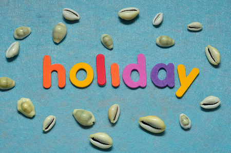 Sea shells displayed with the word holiday