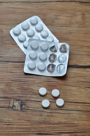 White pills displayed with two blister packsの写真素材
