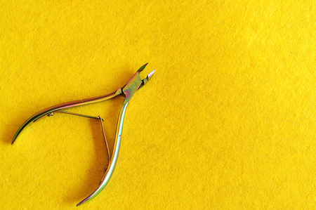 Nail clipper on a yellow backgroundの写真素材