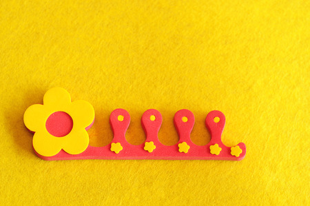 A toe separator on a yellow backgroundの写真素材