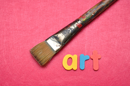 A paintbrush on a pink background with the word artの写真素材