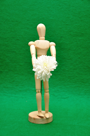 A wooden mannequin display with a white asterの写真素材