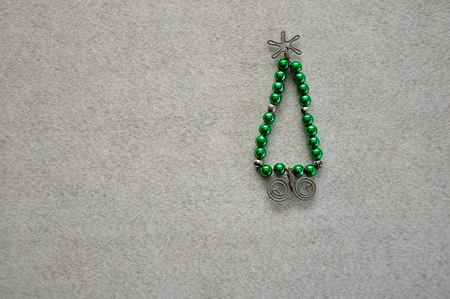 A christmas tree made out of beads and wire on a white backgroundの写真素材