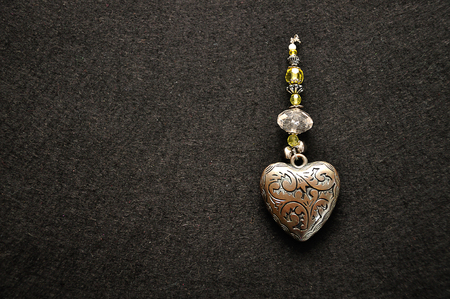 A decorated steel heart on a black backgroundの写真素材