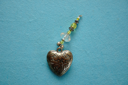A decorated steel heart on a blue backgroundの写真素材