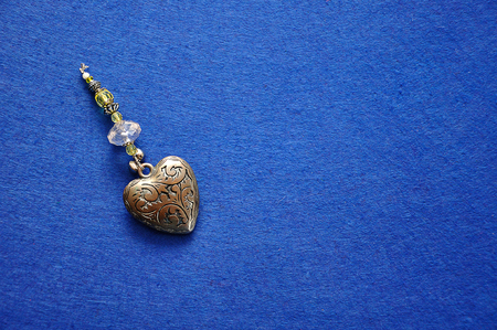 A decorated steel heart on a blue background