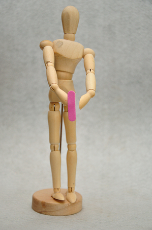 A wooden mannequin holding a letter lの写真素材