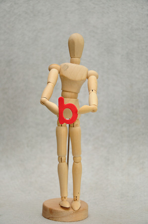 A wooden mannequin holding a letter bの写真素材