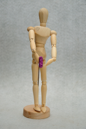 A wooden mannequin holding a letter iの写真素材