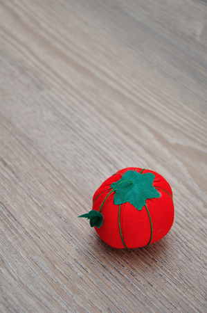 A pin cushion shaped as a red tomatoの写真素材