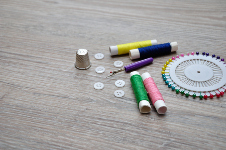 A variety of needle work supplies on a wooden backgroundの写真素材