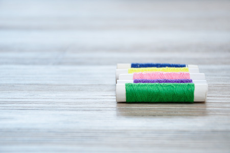 A row of rolls of thread with only one in focusの写真素材
