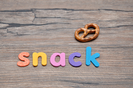 A golden brown pretzel with the word snackの写真素材