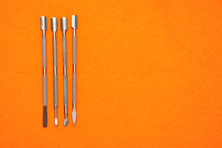 A set of nail tools on an orange backgroundの写真素材