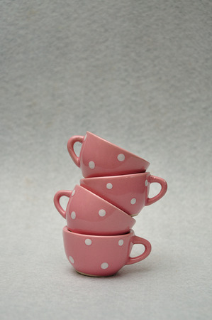A stack of spotted porcelain tea cupsの写真素材