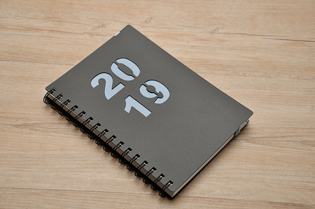 A diary for 2019 on a wooden backgroundの写真素材