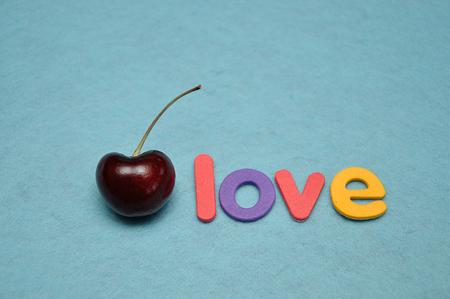 A single cherry with the word loveの写真素材
