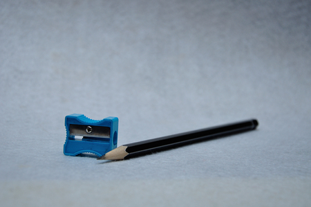 A pencil and sharpener on a white backgroundの写真素材