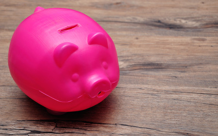 A plastic piggy bank on a tableの写真素材
