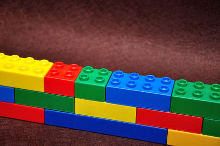 A row of color building blocks built as a wallの写真素材